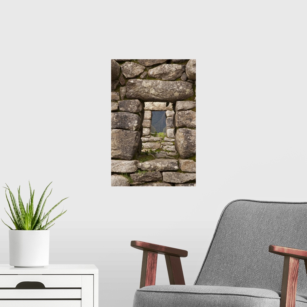 A modern room featuring South America, Peru, Machu Picchu. Aligned windows in stone house ruins. (UNESCO World Heritage S...