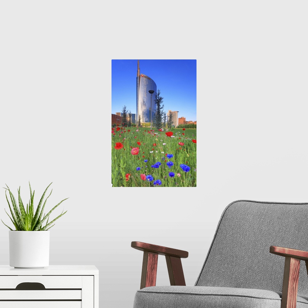 A modern room featuring Italy, Lombardy, Milano district, Milan, Porta Nuova, Flowers and the Unicredit Tower at dawn.