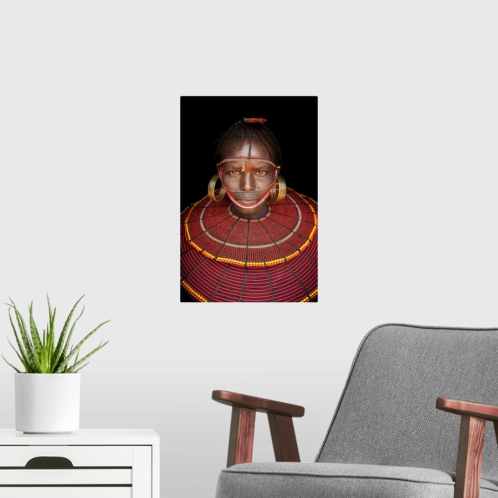 A modern room featuring Kenya, Central, Pokot girl in traditional clothing.
