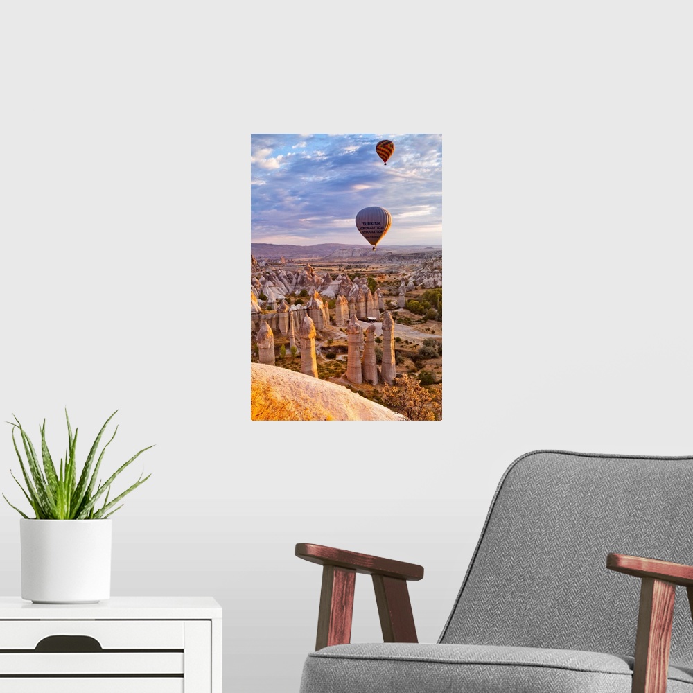 A modern room featuring Turkey, Central Anatolia, Cappadocia, Goreme, Hot air balloons over the Honey Valley at sunrise.