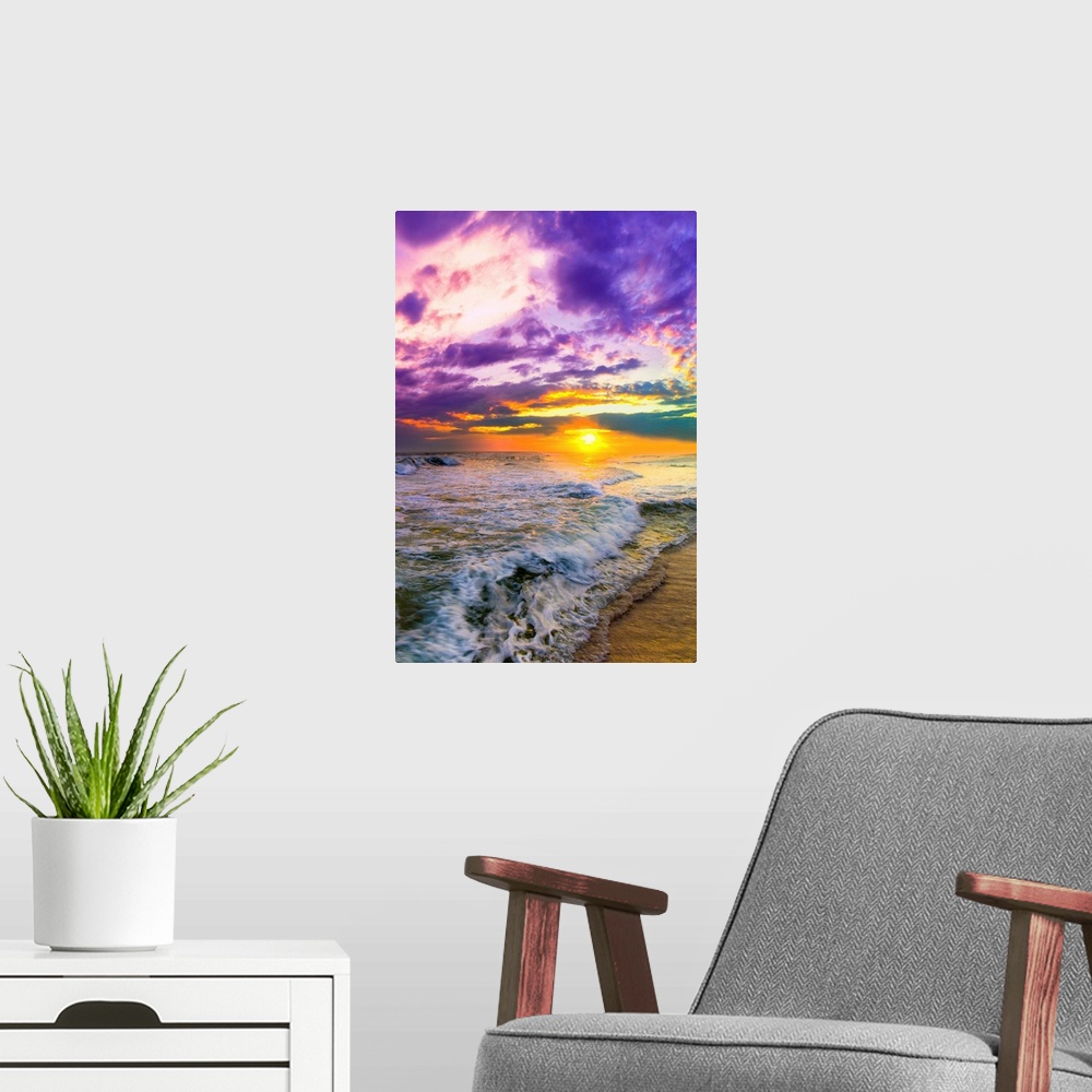 A modern room featuring A pink and purple beach sunset over the ocean. The expansive vertical sky is excellent for a vert...
