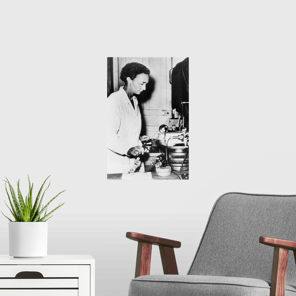 A modern room featuring Irene Joliot-Curie, French nuclear physicist and daughter of Marie Curie at work in her lab. c. 1...