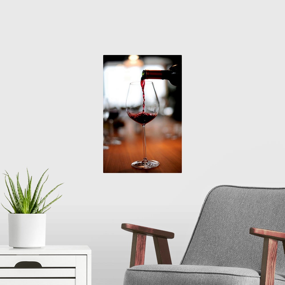 A modern room featuring Red Wine Being Poured Into A Glass