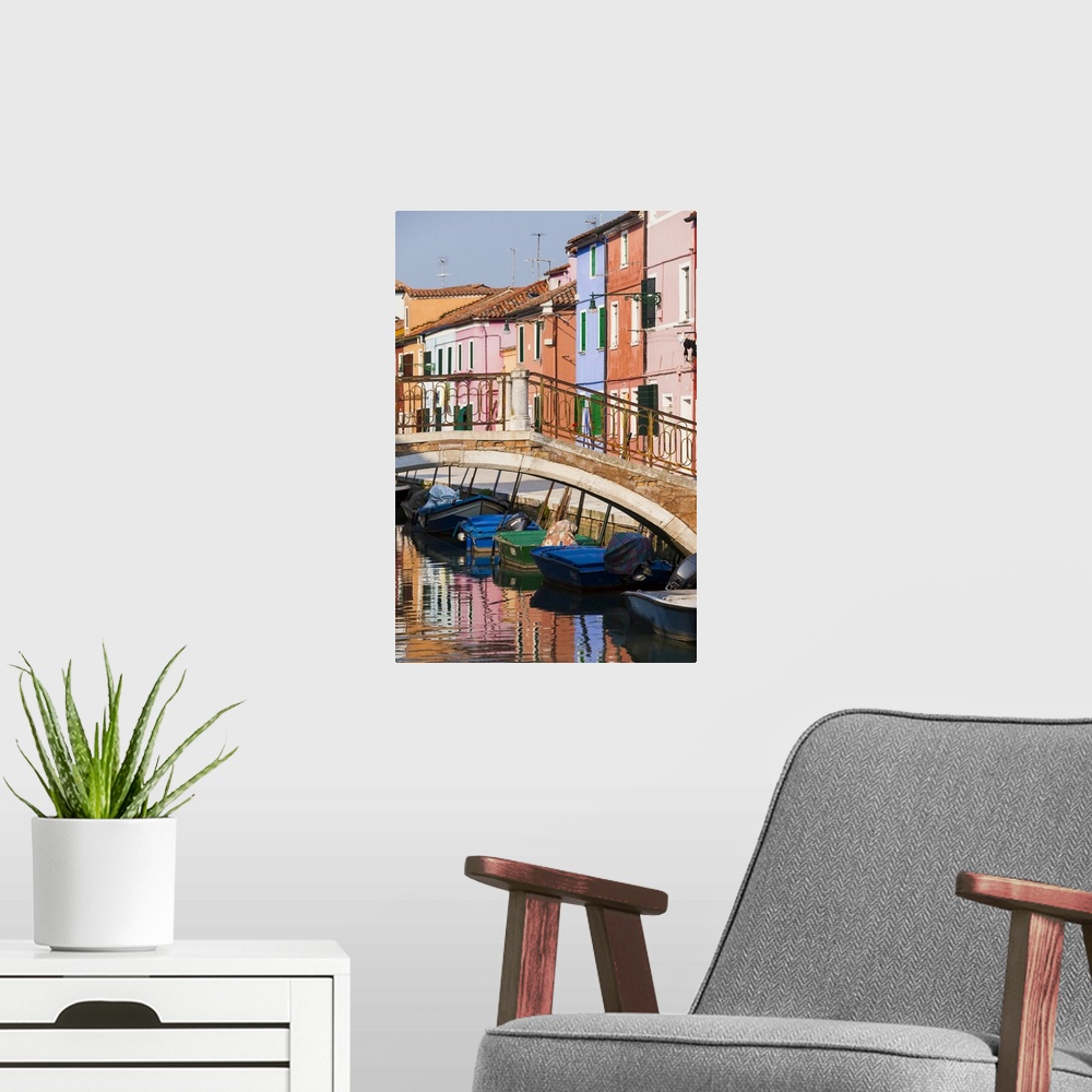 A modern room featuring Italy, Burano. Reflection of colorful houses in canal.