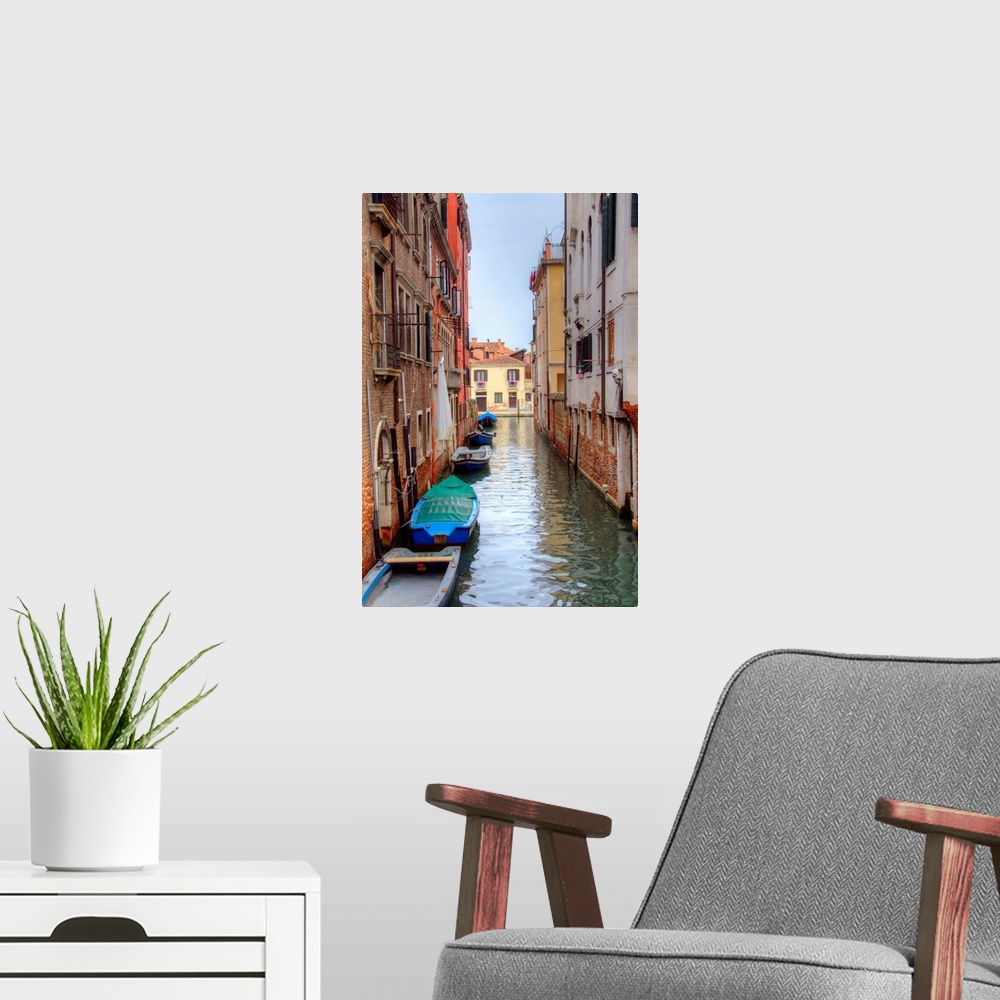 A modern room featuring HDR photograph of a canal flowing through the alleys of Venice, Italy, with small boats floating ...