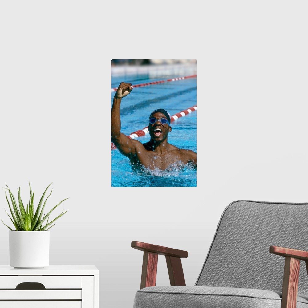 A modern room featuring portrait of a young male swimmer raising his hands in victory