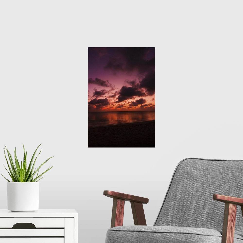 A modern room featuring Aruba, sea at sunset