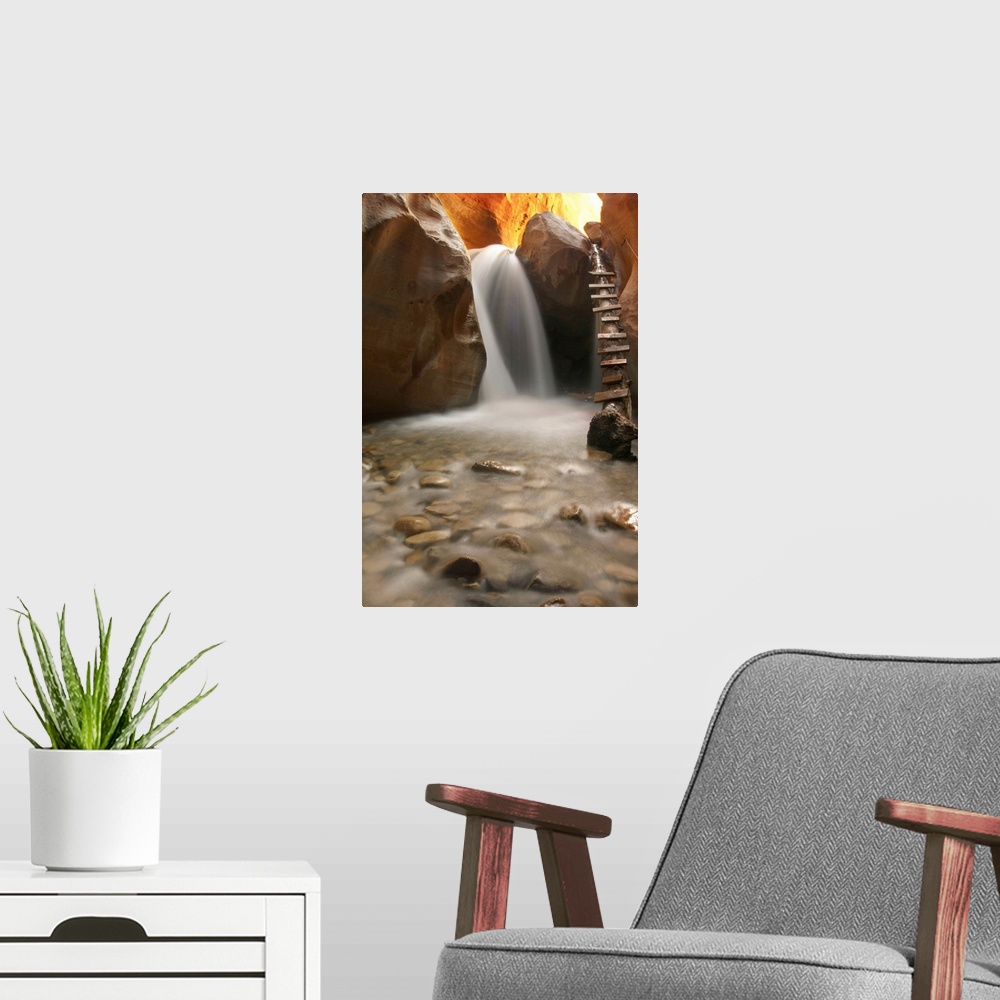 A modern room featuring Beautiful waterfall with pebbles on foreground.