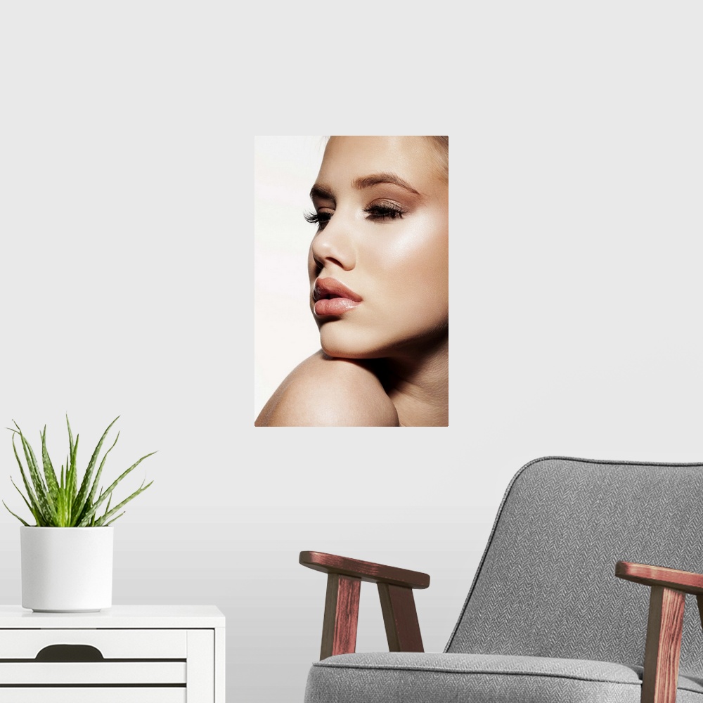 A modern room featuring Close-up of young female face, beauty portrait, blue eyes, clear skin, professional make-up.