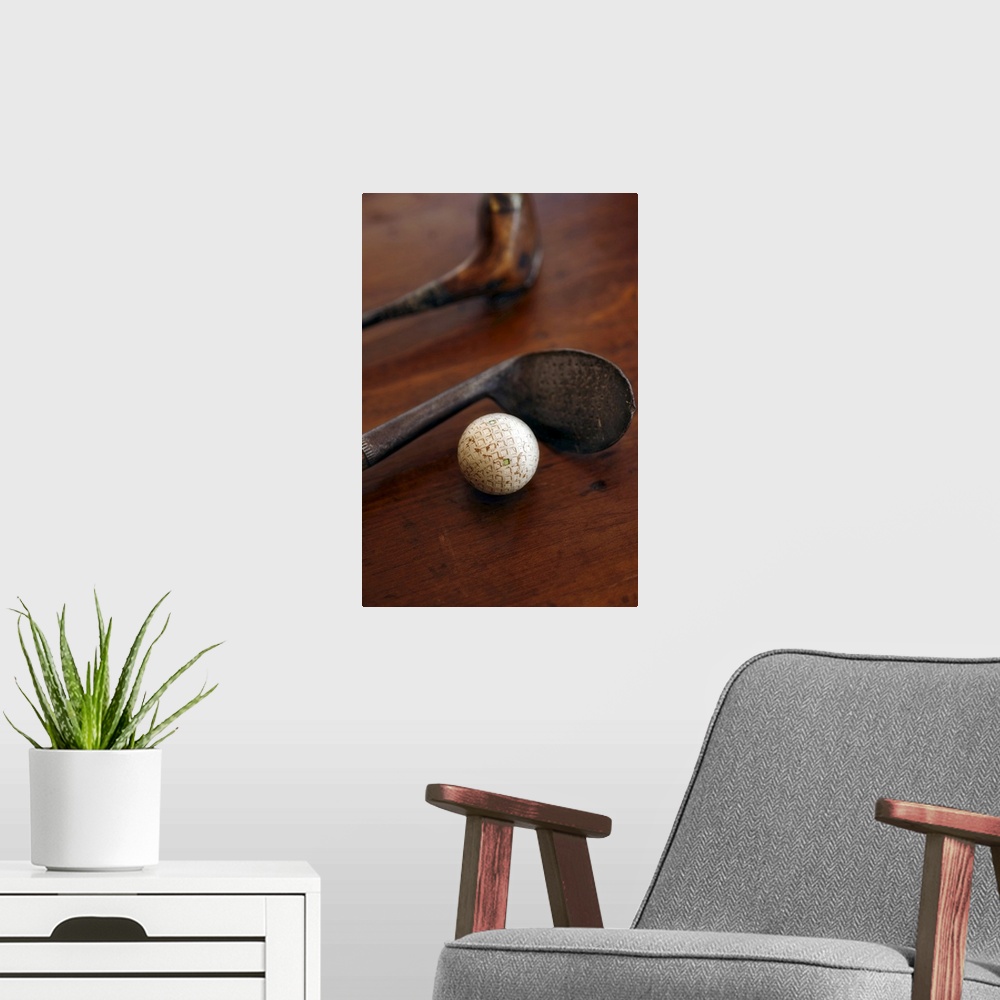 A modern room featuring Close up of antique golf clubs and golf ball