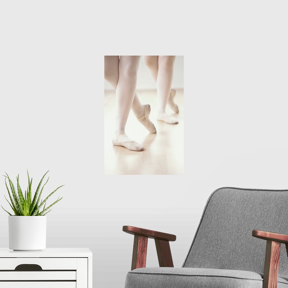 A modern room featuring close-up of two ballet dancer's feet