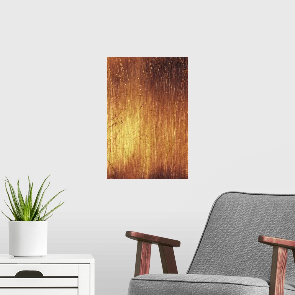 A modern room featuring Vertical abstract painting of different lines etched together closely with warm tones.