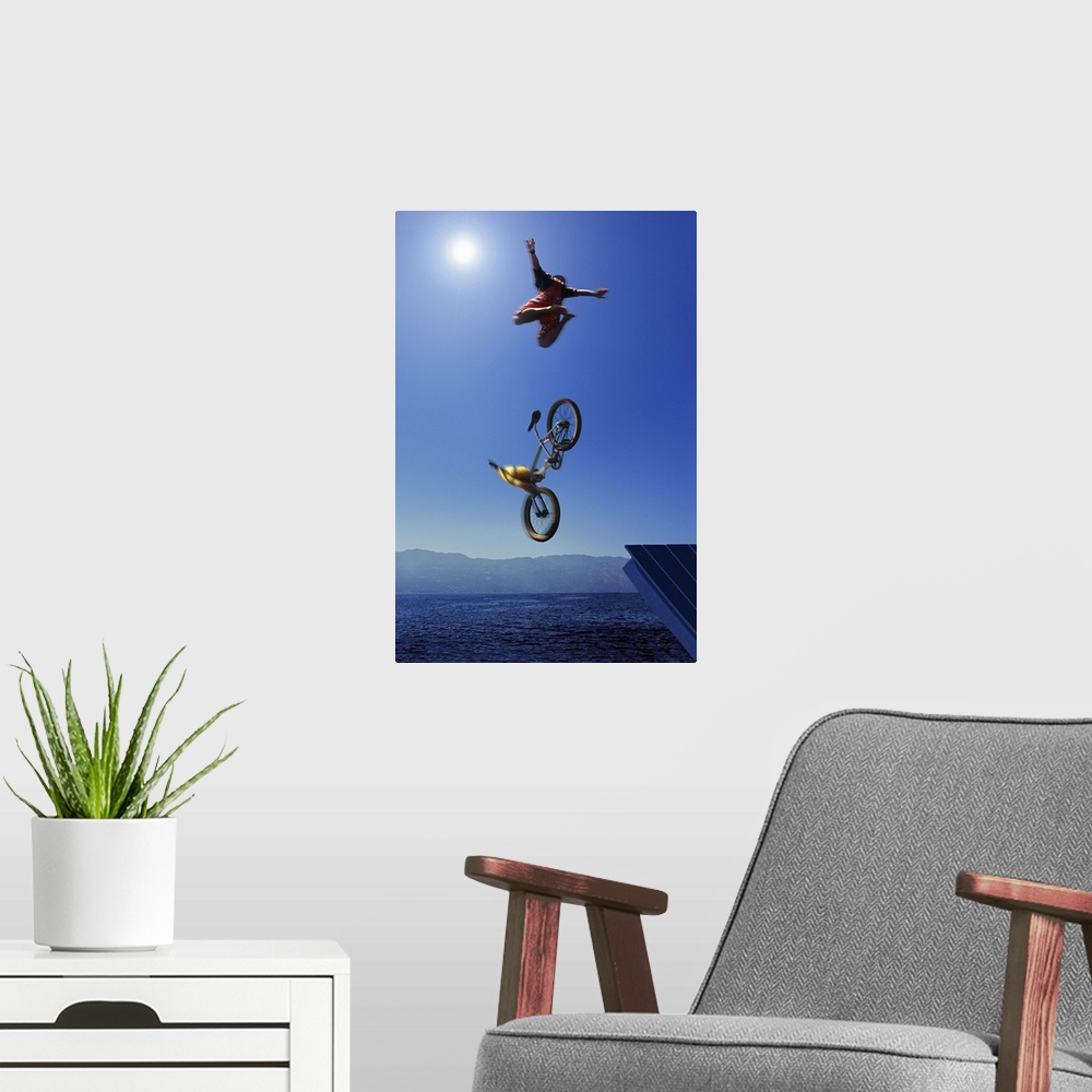 A modern room featuring Cyclist going off jump into water