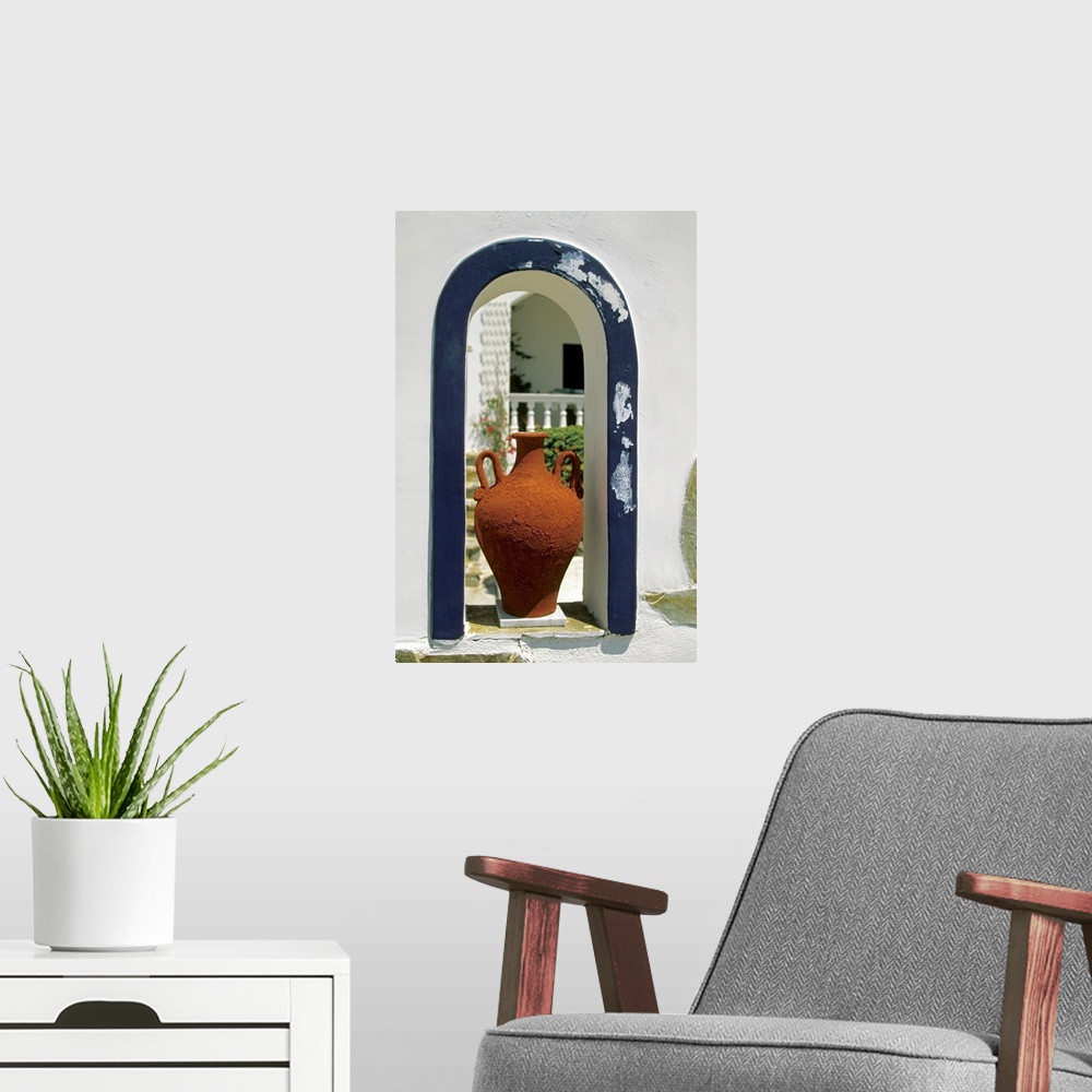A modern room featuring Decorative vase placed on an arched window of a house, Santorini, Greece