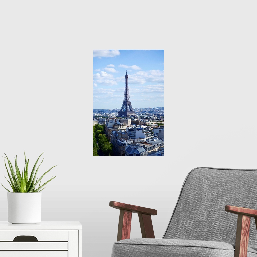 A modern room featuring Eiffel Tour against clouds in sky.
