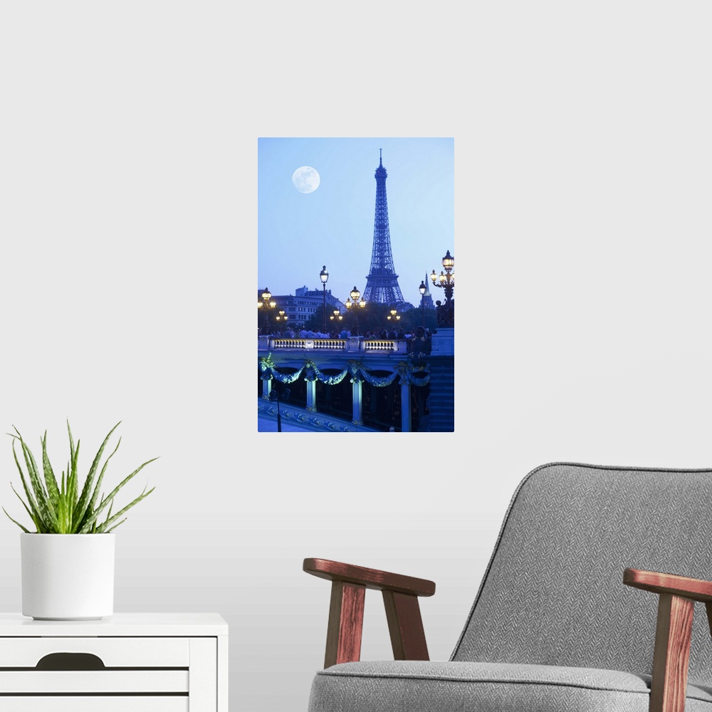 A modern room featuring Eiffel tower at dusk with moonrise