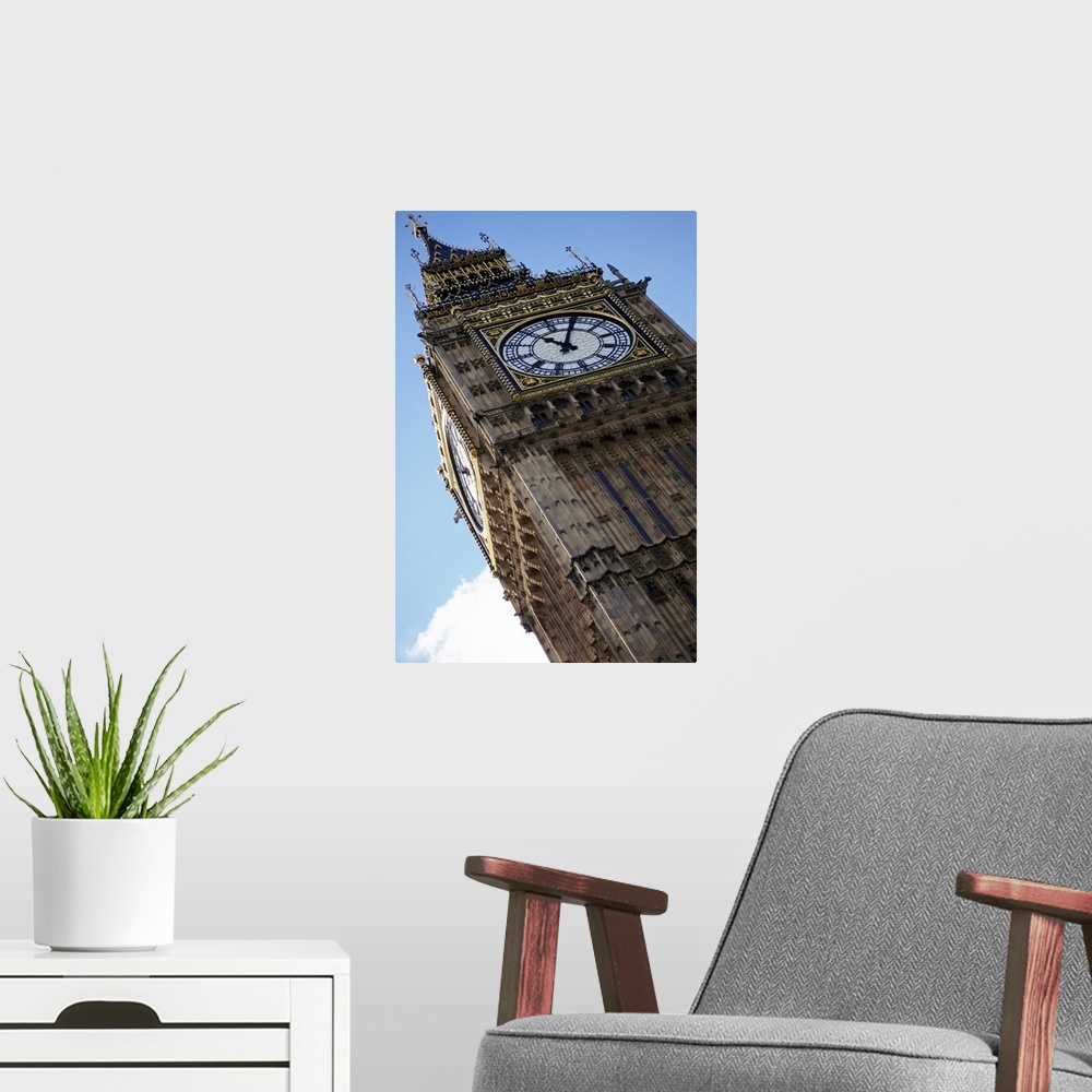 A modern room featuring Big Ben is photographed from below showing mostly the top of the structure at an angle.