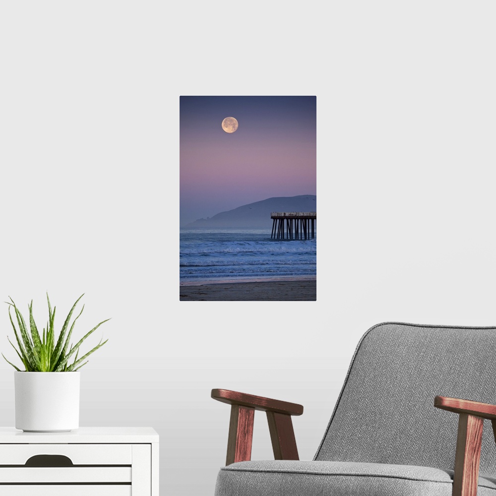 A modern room featuring Full moon sets over  Pismo Beach at sunrise on winter morning.