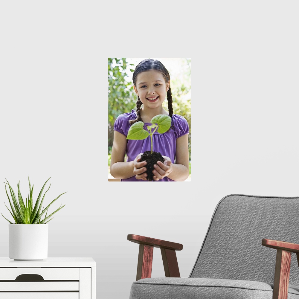 A modern room featuring Girl holding soil and plant