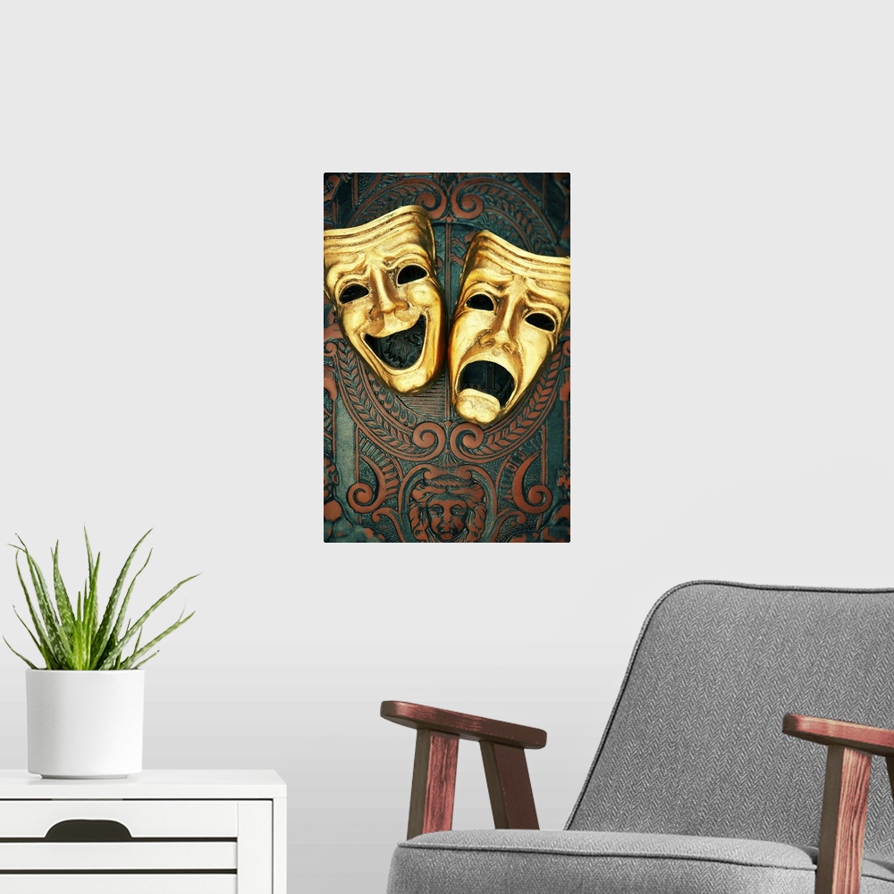 A modern room featuring Golden comedy and tragedy masks on patterned leather