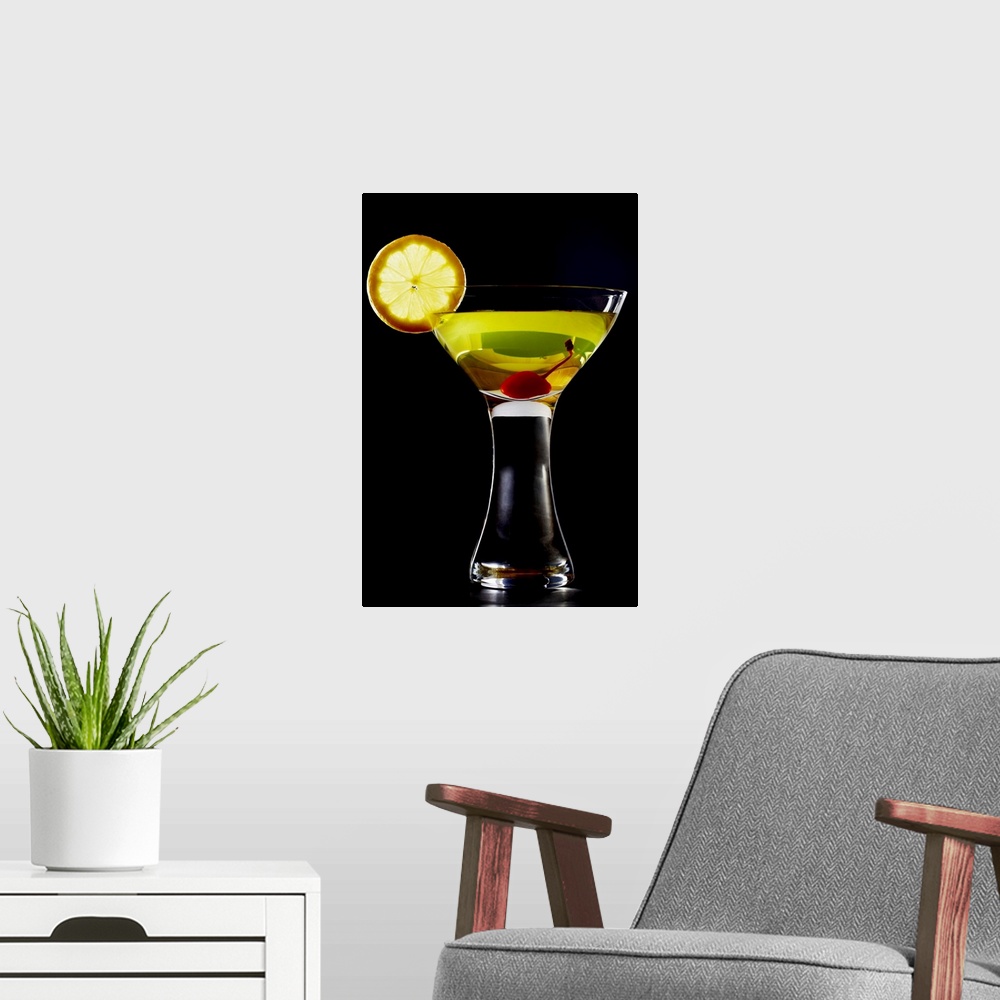 A modern room featuring Green coloured cocktail with cherry and orange slice, close-up