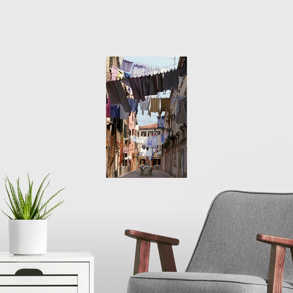 A modern room featuring Italy, Venice, lines of washing hanging between buildings in sunny street