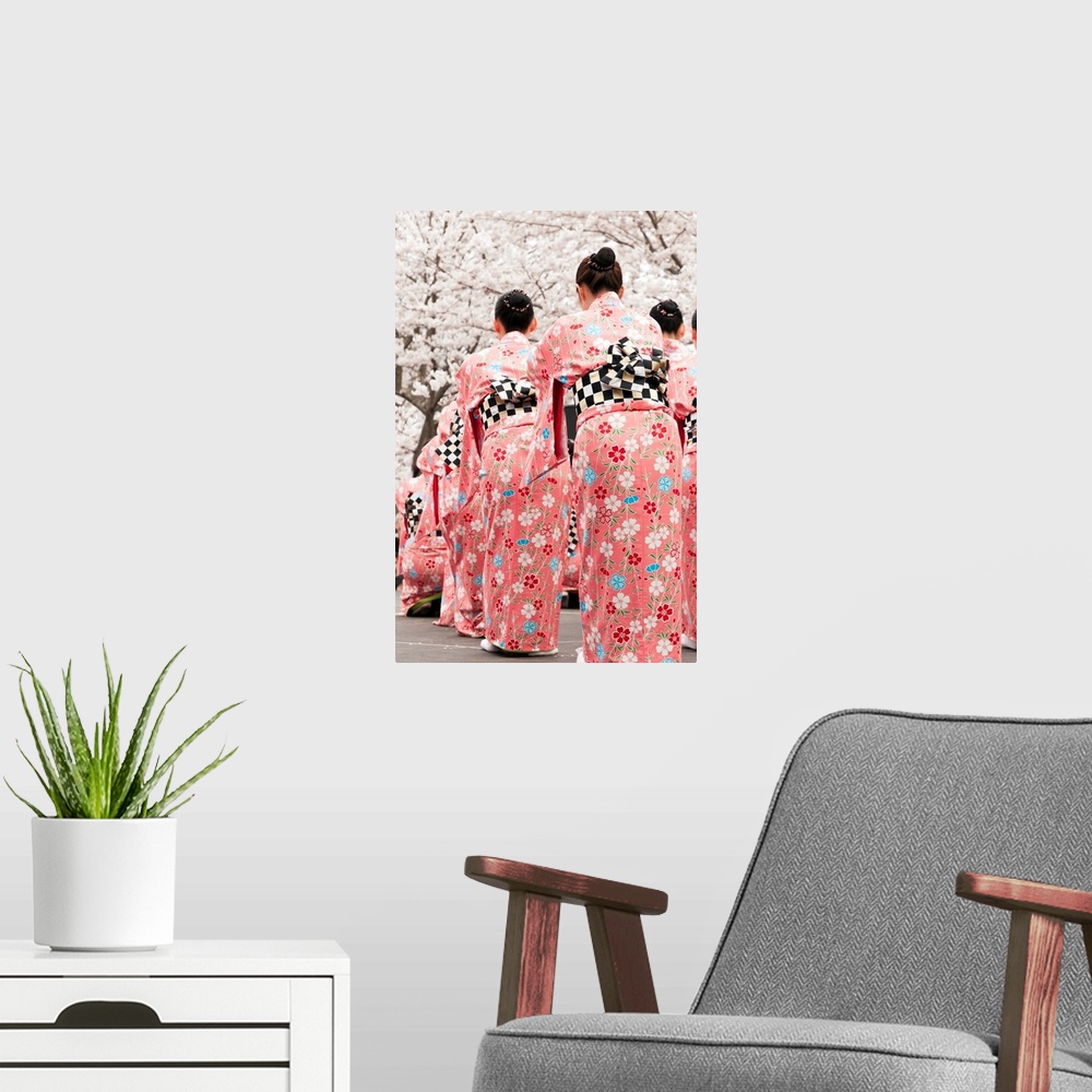 A modern room featuring Group of female Japanese dancers in traditional costumes celebrate cherry blossom at spring festival