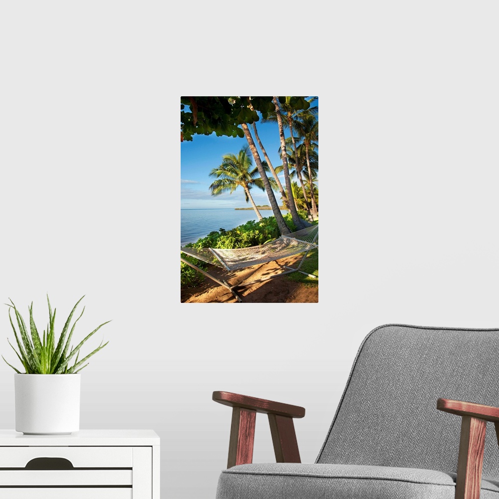 A modern room featuring Palm trees near Kaunakakai, fronting Hotel Molokai with hammock in foreground, Molokai, Hawaii