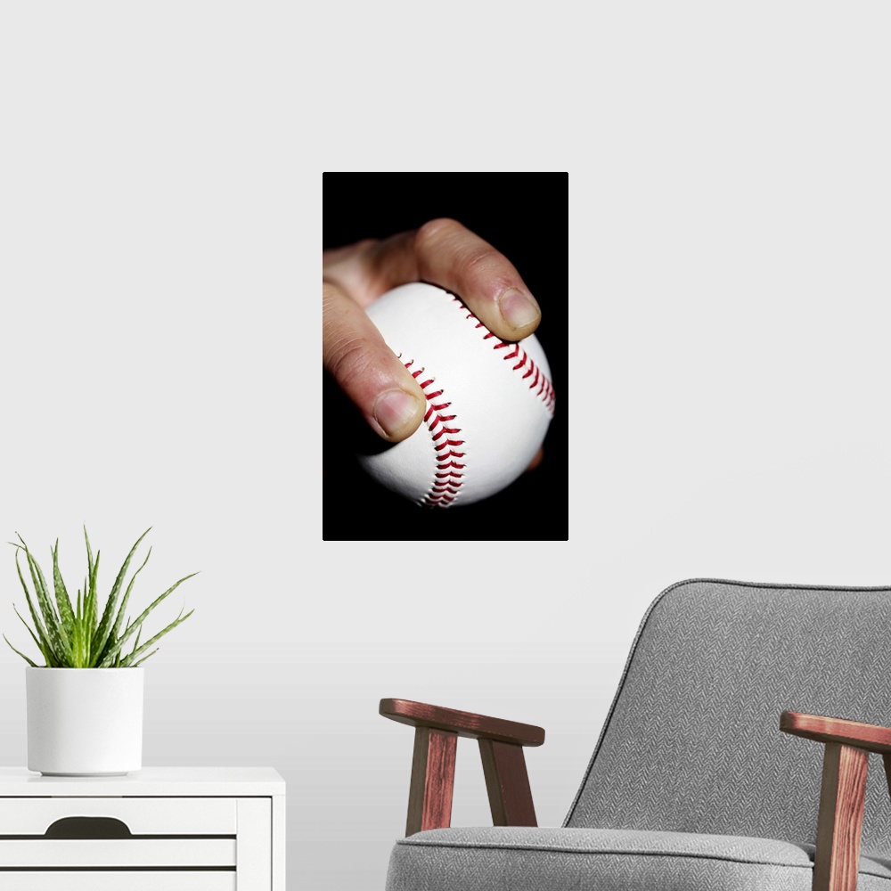 A modern room featuring Pitchers hand gripping a baseball