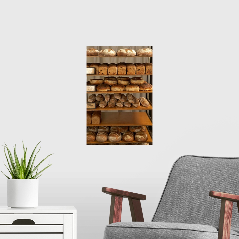 A modern room featuring Rack with loaves of bread in bakery