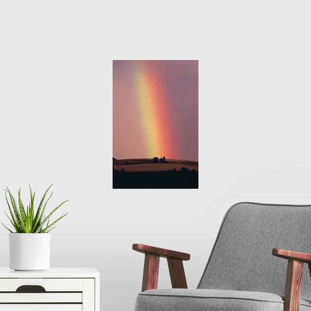 A modern room featuring Rainbow in a sunset sky