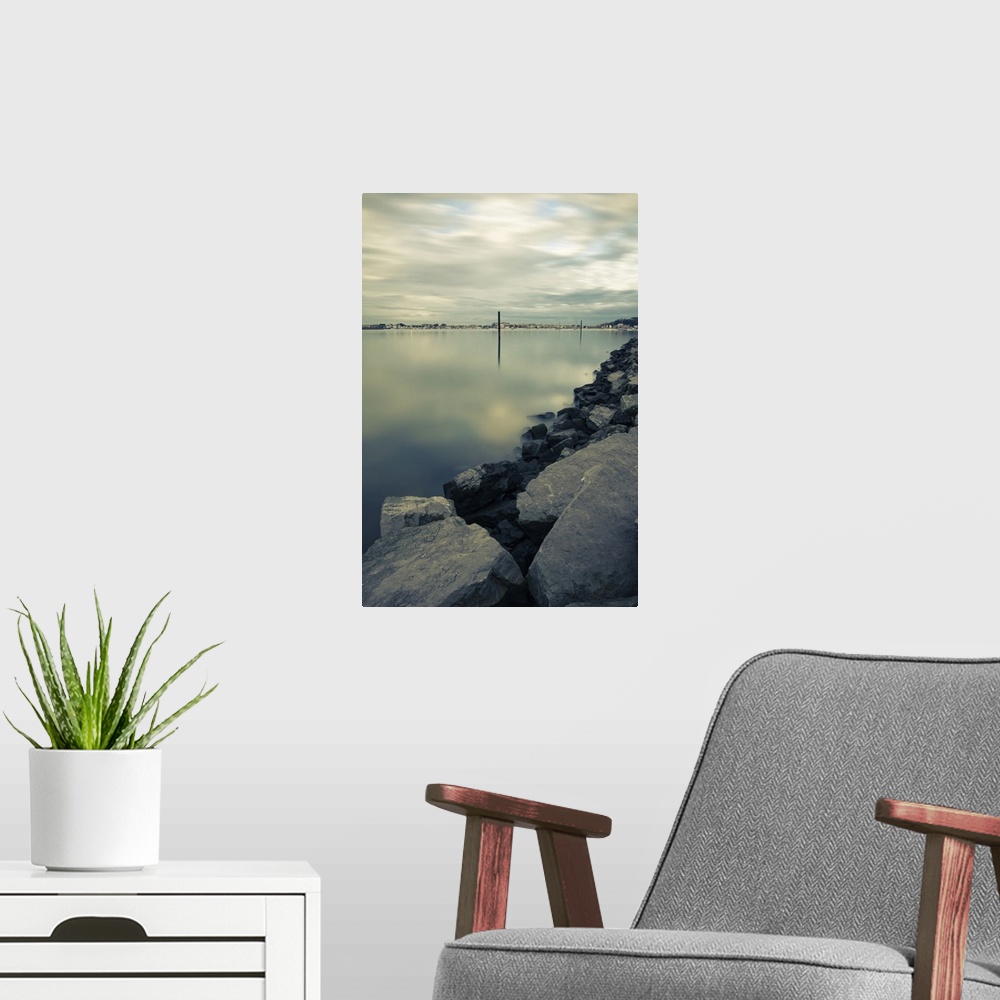 A modern room featuring Scenic view on shoreline harbor with boat pole in atlantic ocean in long exposure, Basque country...