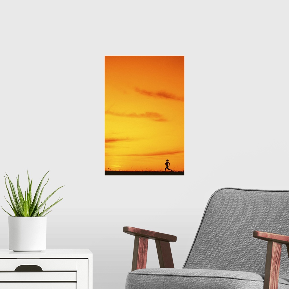 A modern room featuring Silhouette of runner at sunset