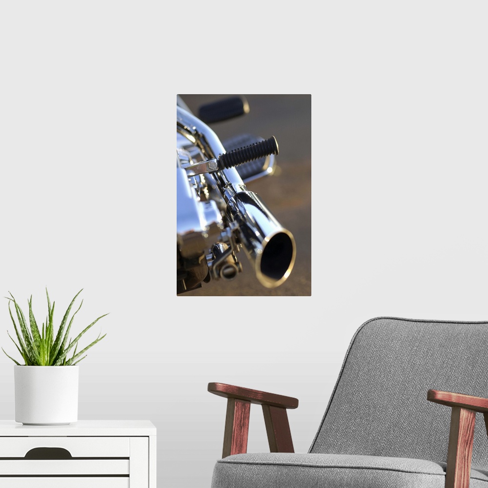 A modern room featuring Still-life close-up of a chrome tailpipe of a motorcycle