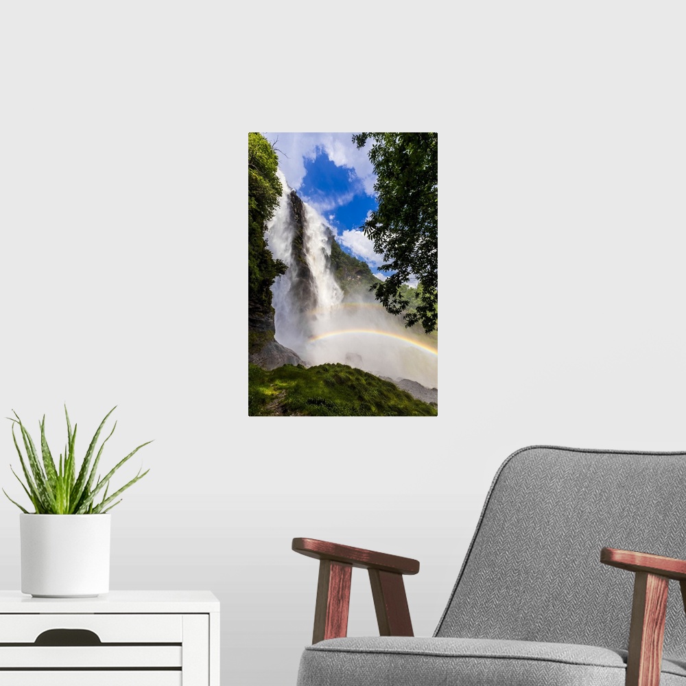 A modern room featuring Acquafraggia Waterfall in spring with a rainbow. Valchiavenna, Valtellina, Lombardy, Italy, Europe.