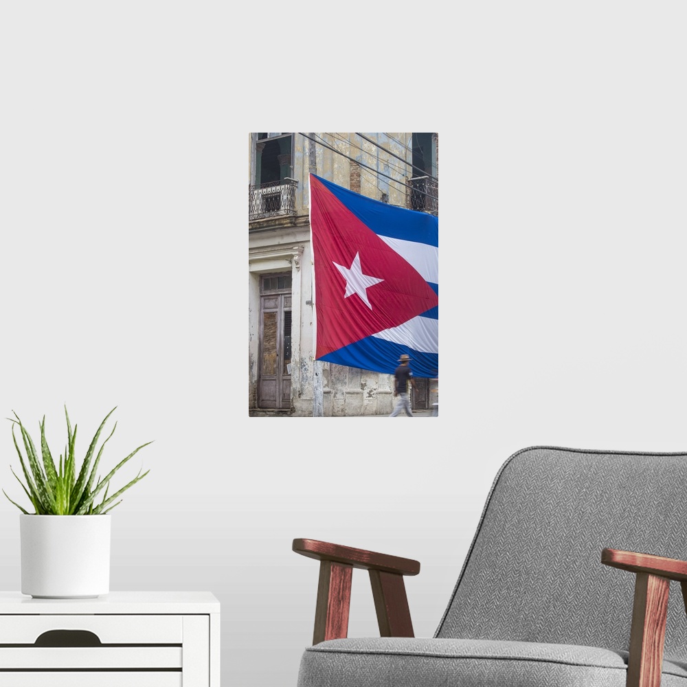A modern room featuring Cuba, Huge Cuban flag hanging across buildings in a street in  Santa Clara, after the death of Fi...