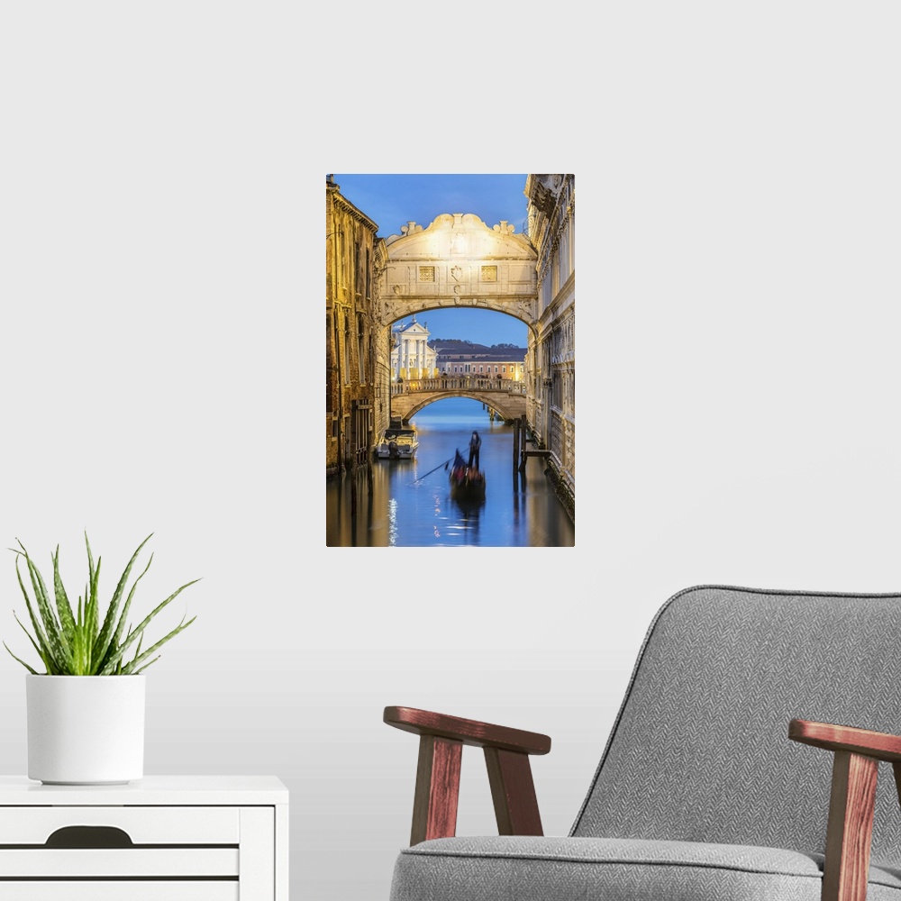 A modern room featuring Italy, Veneto, Venice. Bridge of sighs illuminated at dusk with gondolas