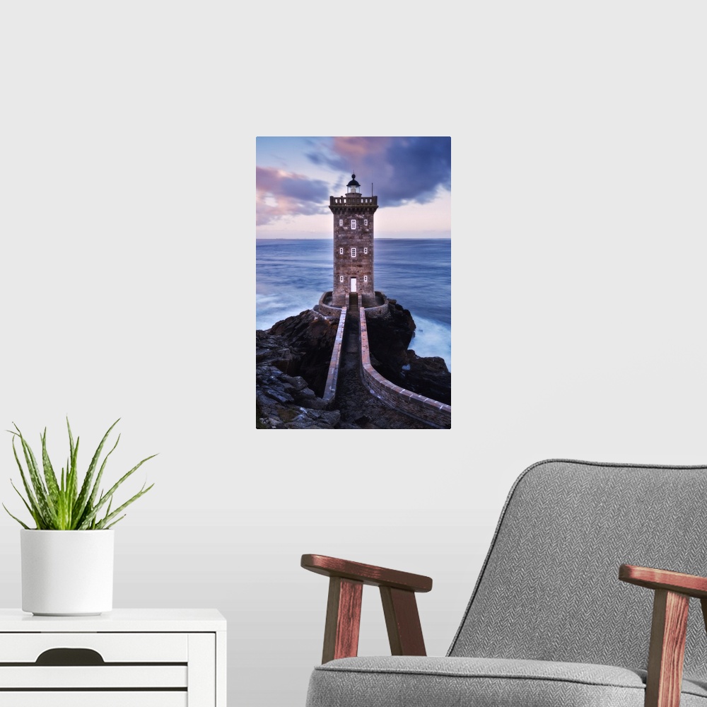 A modern room featuring Kermorvan lighthouse at dawn in Brittany, France.