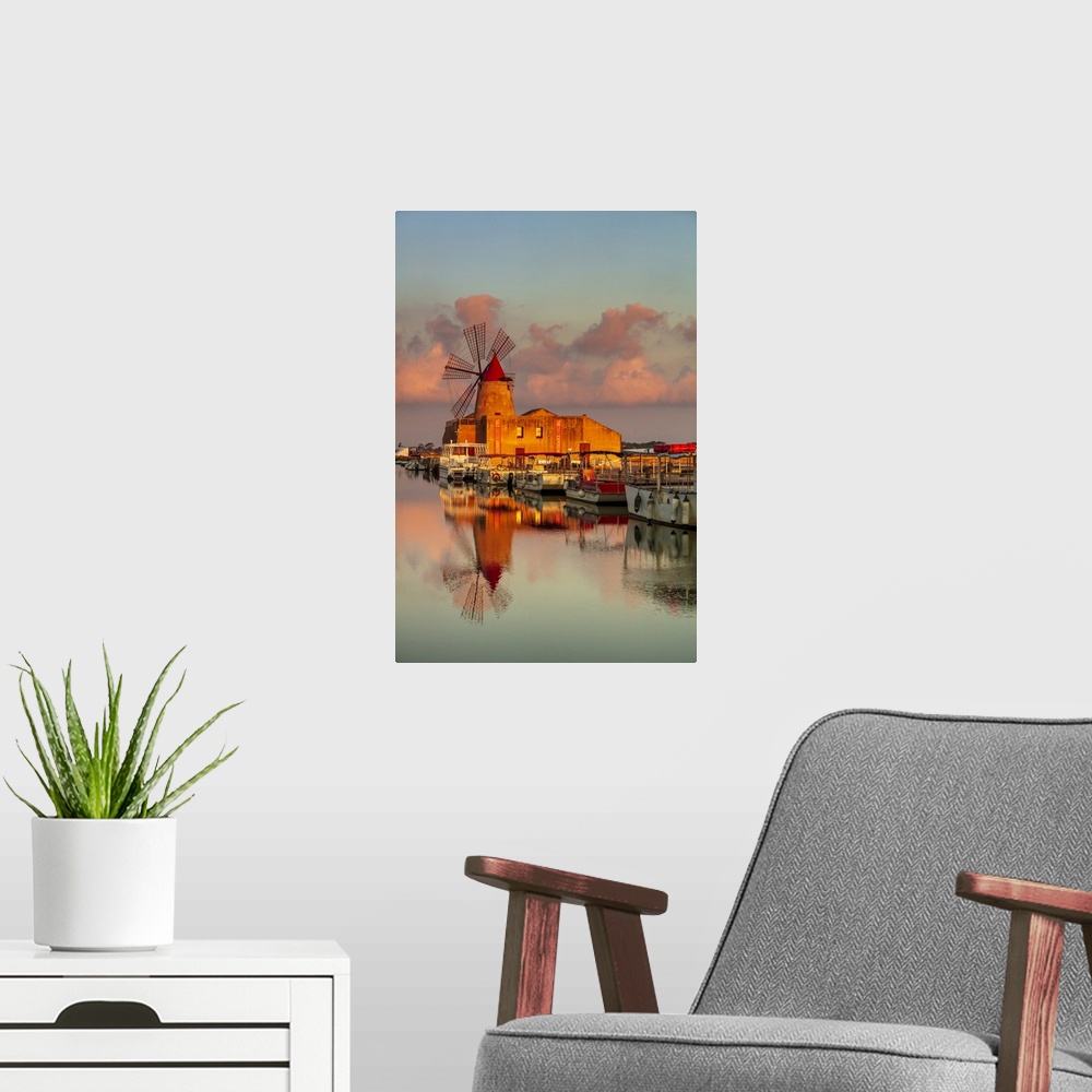 A modern room featuring Marsala, Sicily. Windmills reflecting at sunrise in the saltern be,\tween Marsala and Trapani.