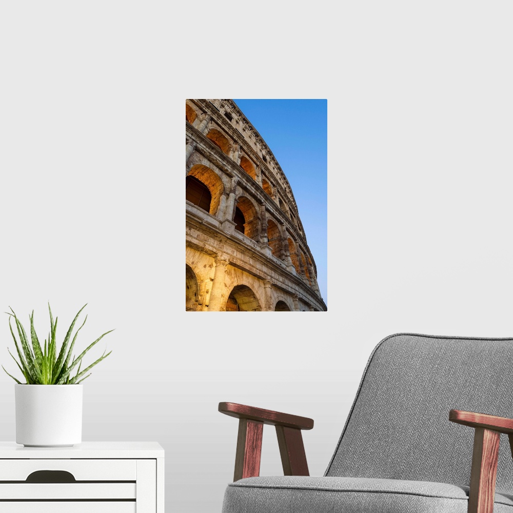 A modern room featuring Rome, Lazio, Italy. Colosseum at summer sunrise.