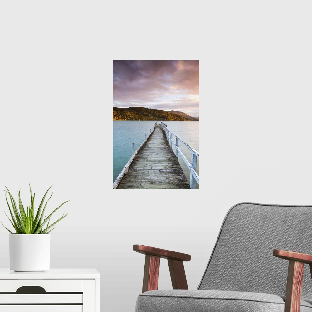 A modern room featuring Sunset over picturesque wharf in idyllic Kenepuru Sound, Marlborough Sounds, South Island, New Ze...
