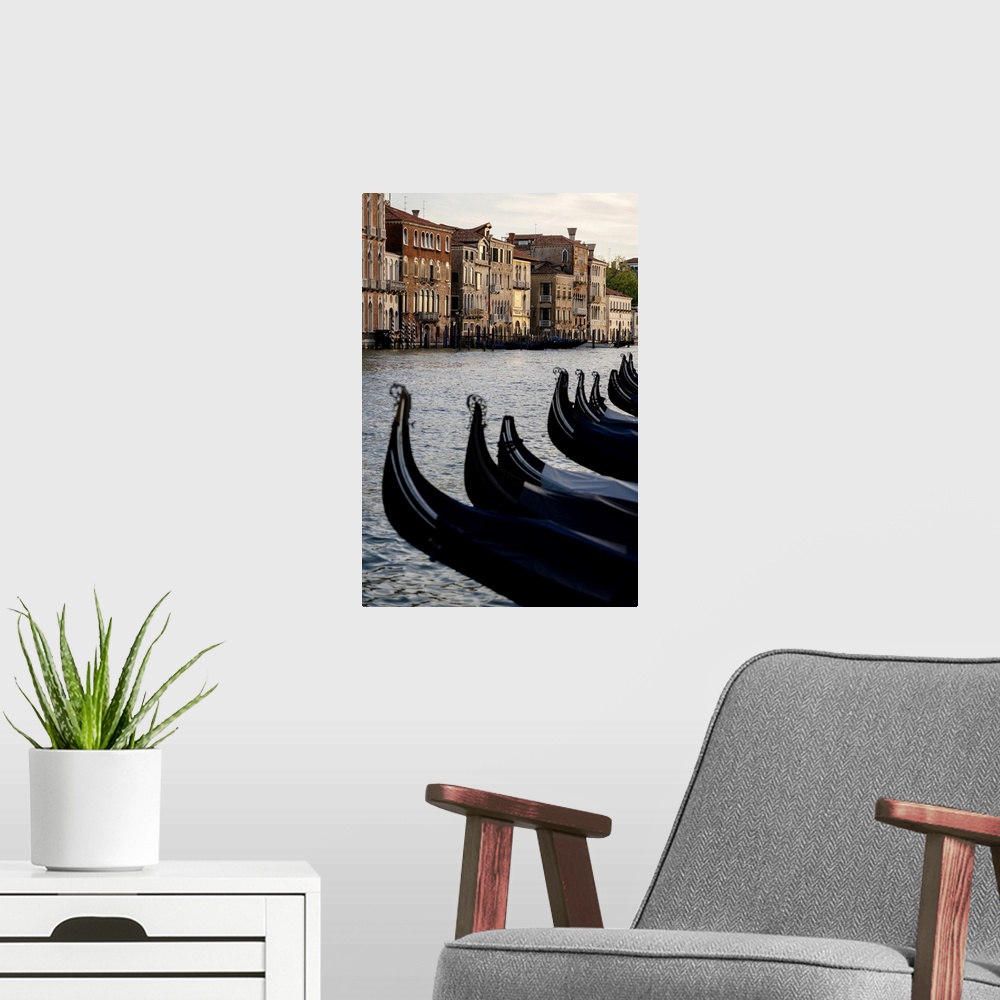 A modern room featuring Venice, Veneto, Italy. Gondolas bows and Grand Canal at sunset.