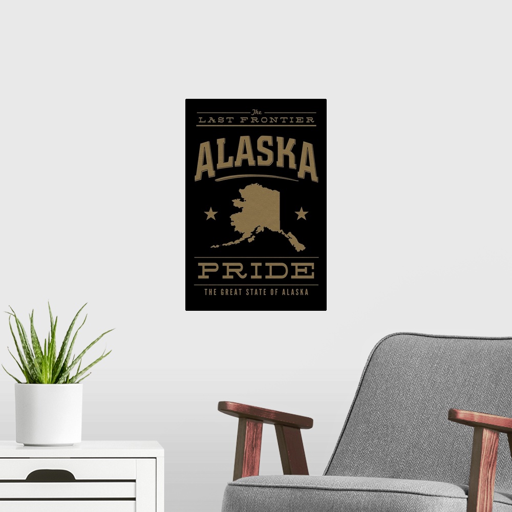 A modern room featuring The Alaska state outline on black with gold text.