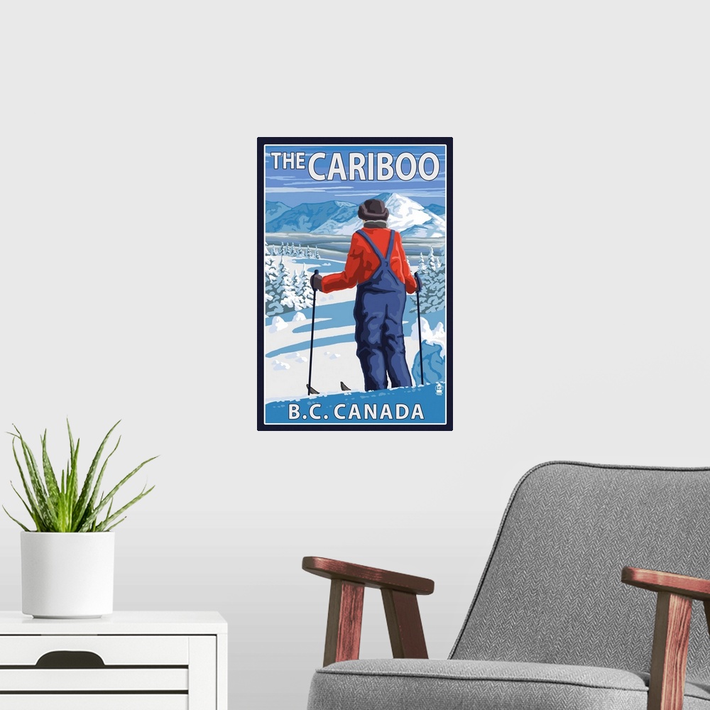 A modern room featuring Retro stylized art poster of a skier stopped and gazing out over a snowy mountainous landscape.