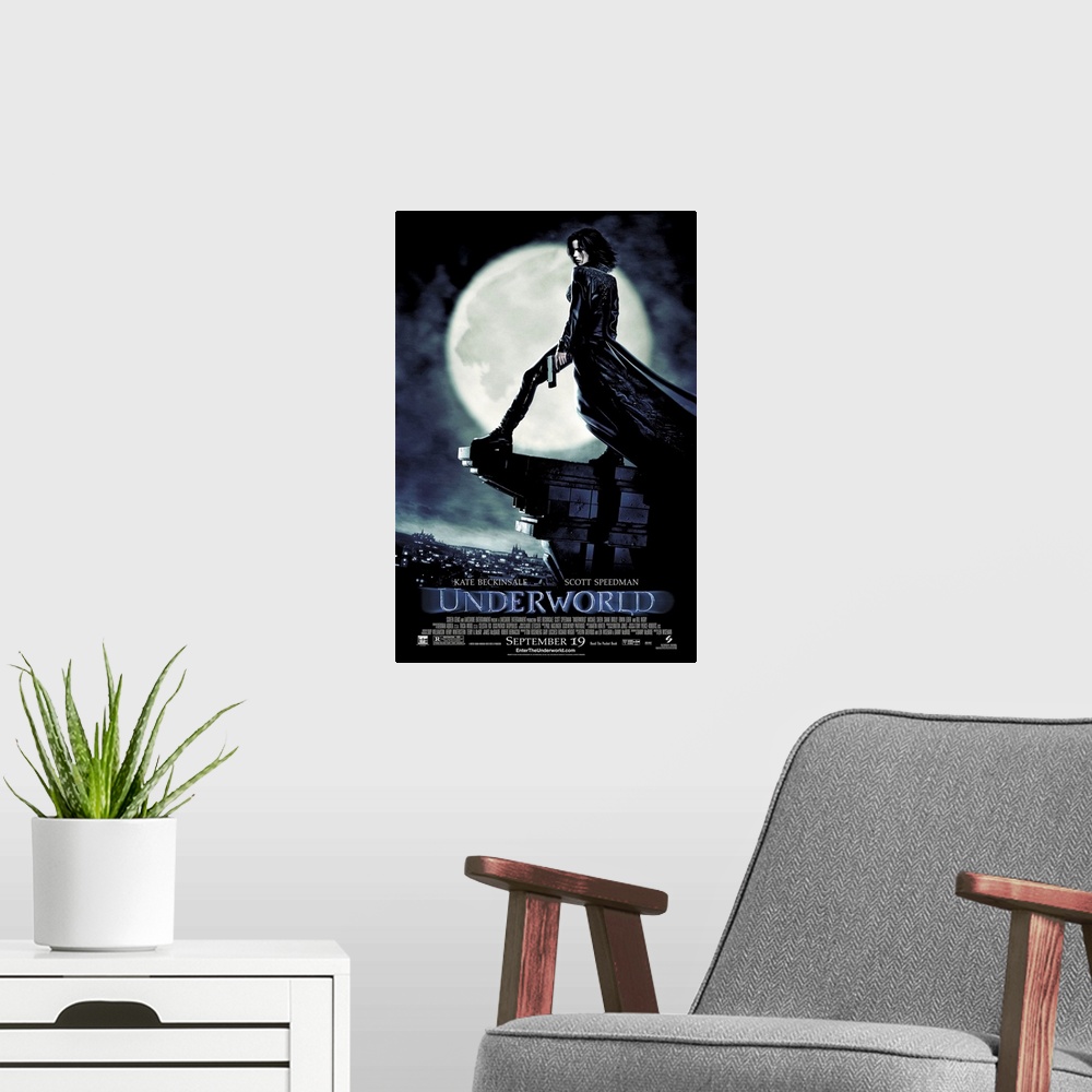 A modern room featuring Large, vertical movie advertisement for Underworld, main character Selene stands with a gun in he...