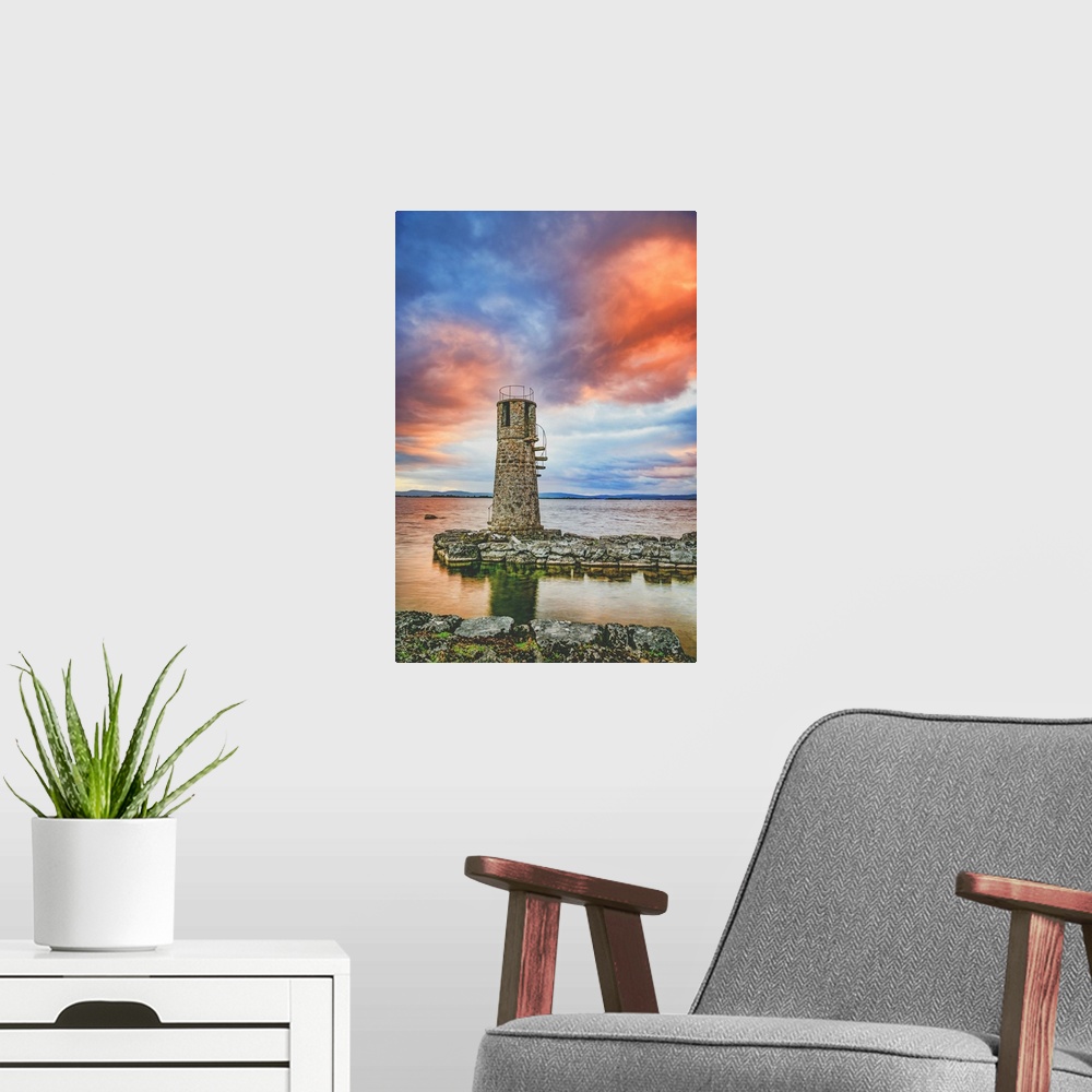 A modern room featuring Sunset over an old lighthouse