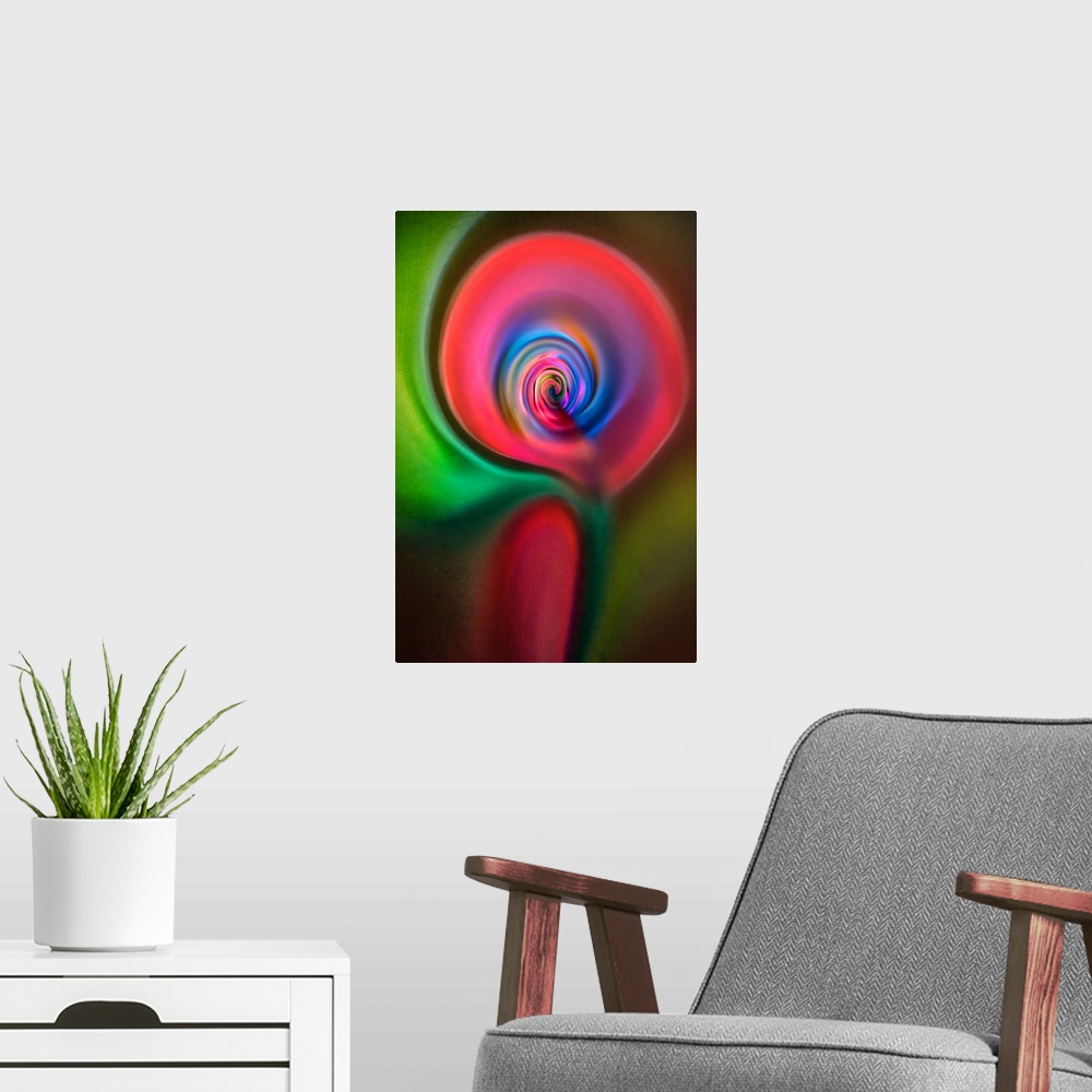 A modern room featuring Abstract photograph in green and red swirling shapes, resembling a candle.