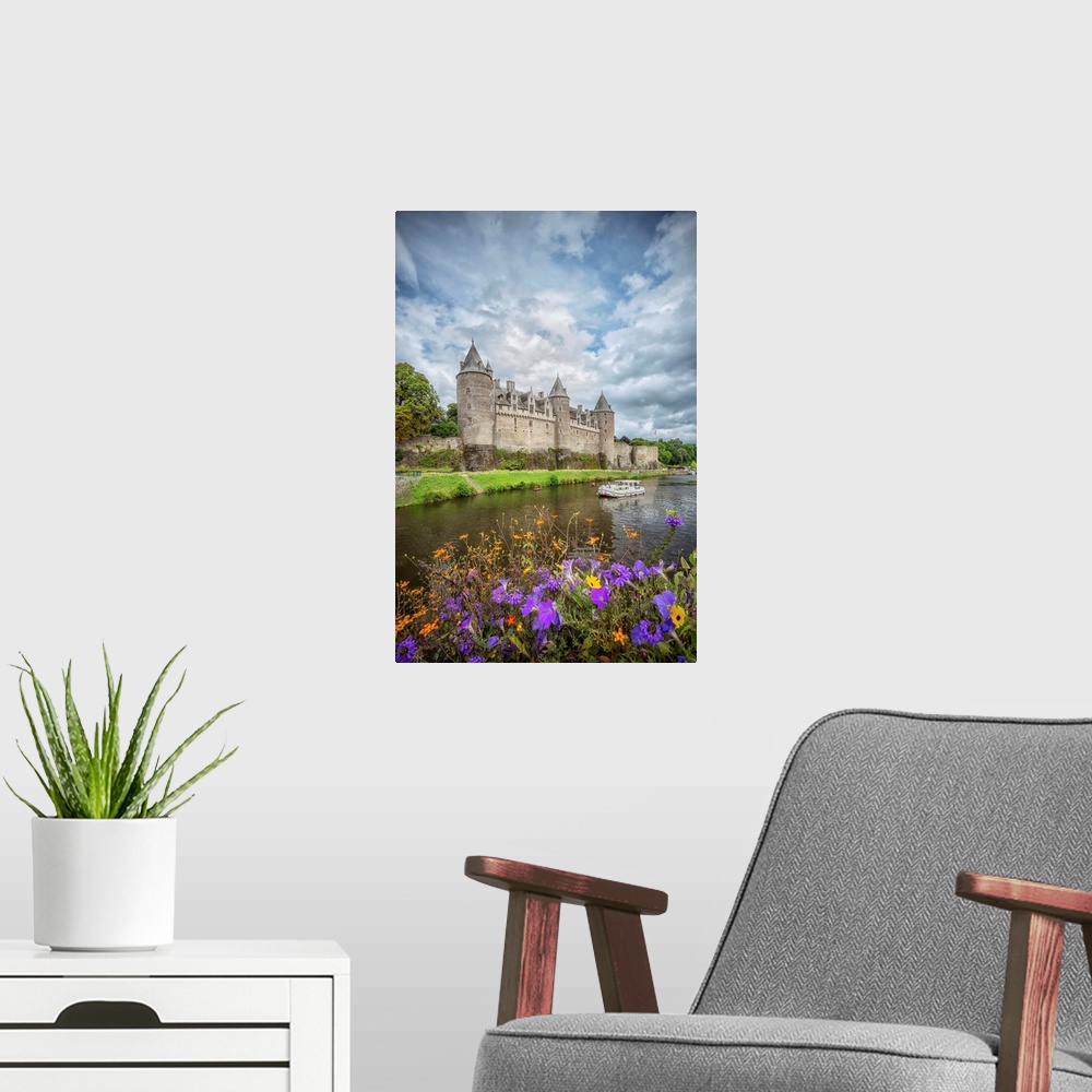 A modern room featuring View of a medieval castle from across the river with flowers.