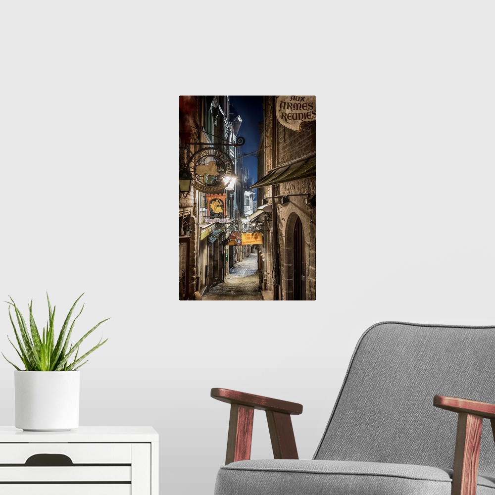 A modern room featuring A photograph of a road in a French village.