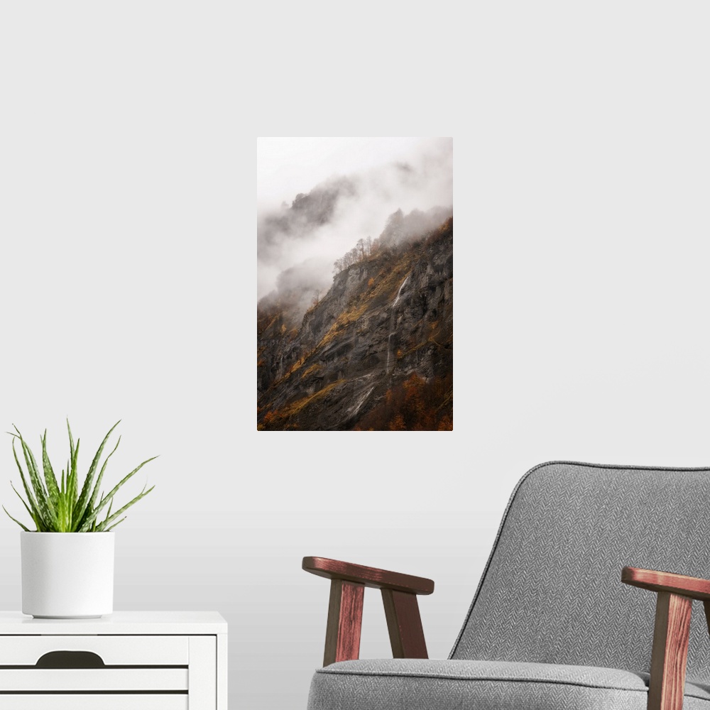 A modern room featuring Vertical view of a moutain in Sixt-Fer-a-Cheval area in the French Alps, some fog and a little wa...